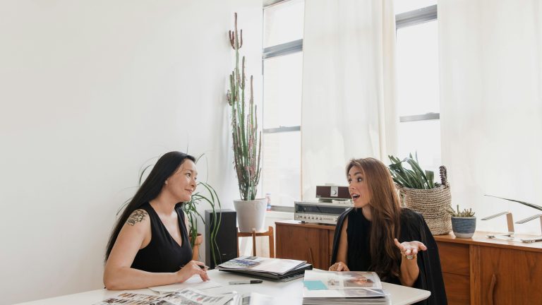 Two business women sitting around a table