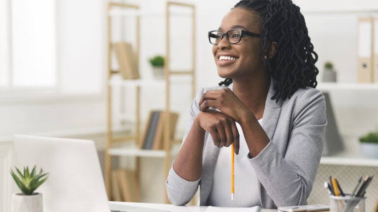 Young Afro Business Lady Smiling Sitting In Modern Office