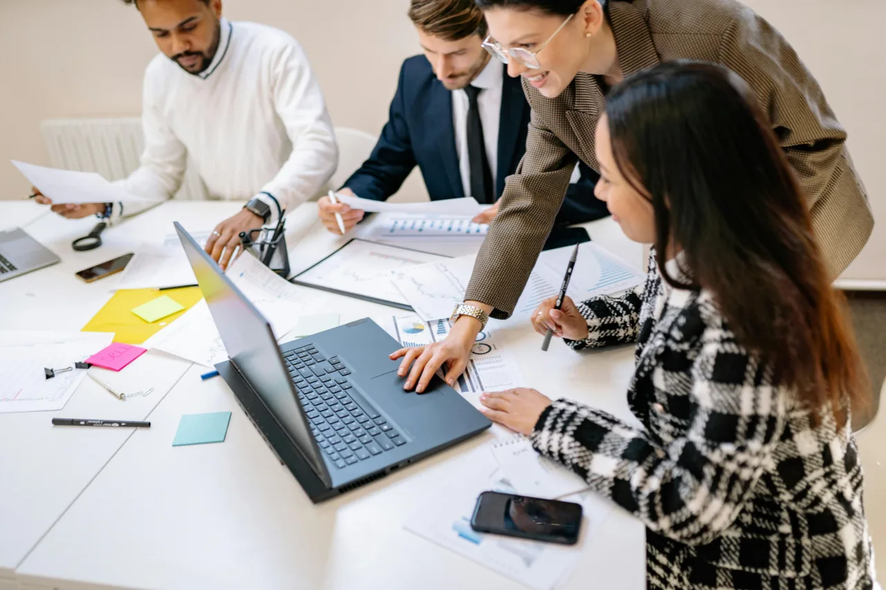Group of staff looking at a computer