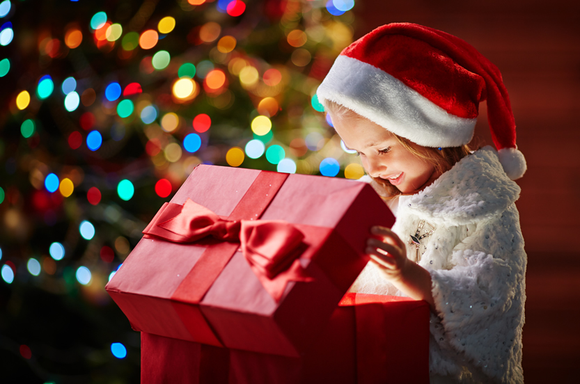 Child opening present on Christmas