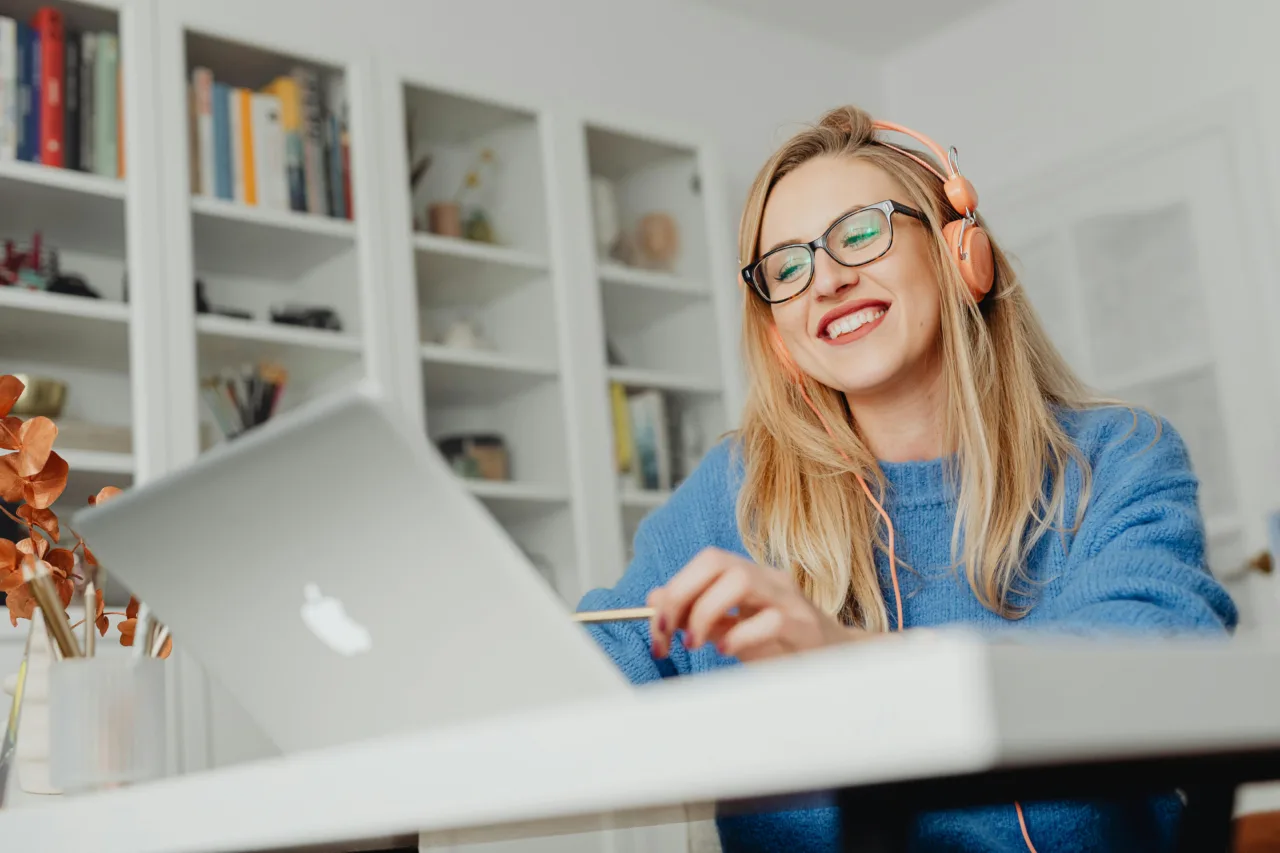 Woman on laptop wearing headphones