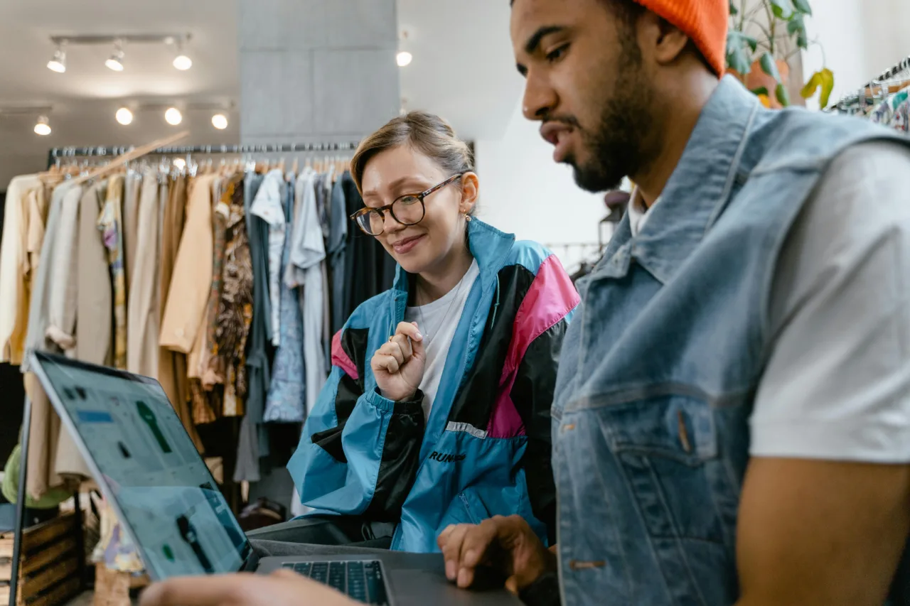 Shop owners admiring their Shopify store on a laptop