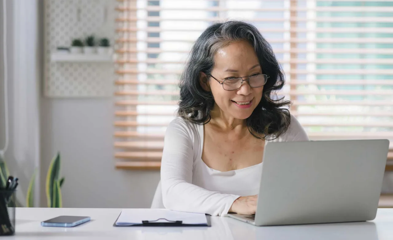 Senior woman working on laptop computer