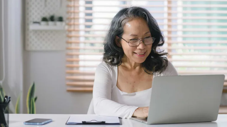 Senior woman working on laptop computer